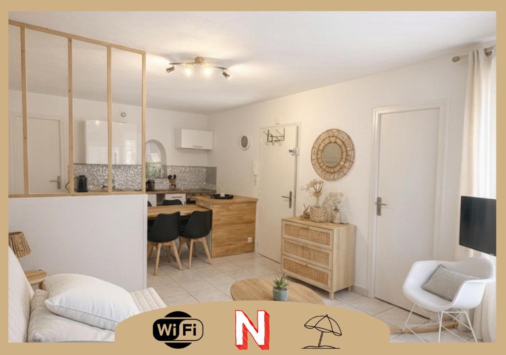 a living room with a kitchen and a dining room at La Perle de la Baie - Plages à pied & Hyper centre in Pornichet