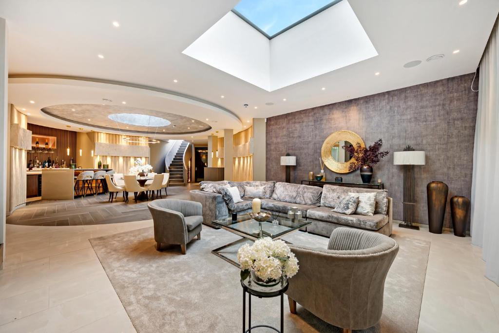 a living room with a couch and a table at Luxurious subterranean mansion - 3 spectacular bedrooms in Altrincham