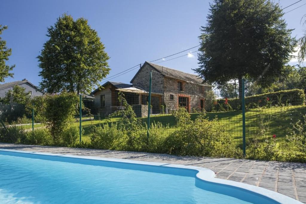 a swimming pool in front of a house at La Ressource in Cherain