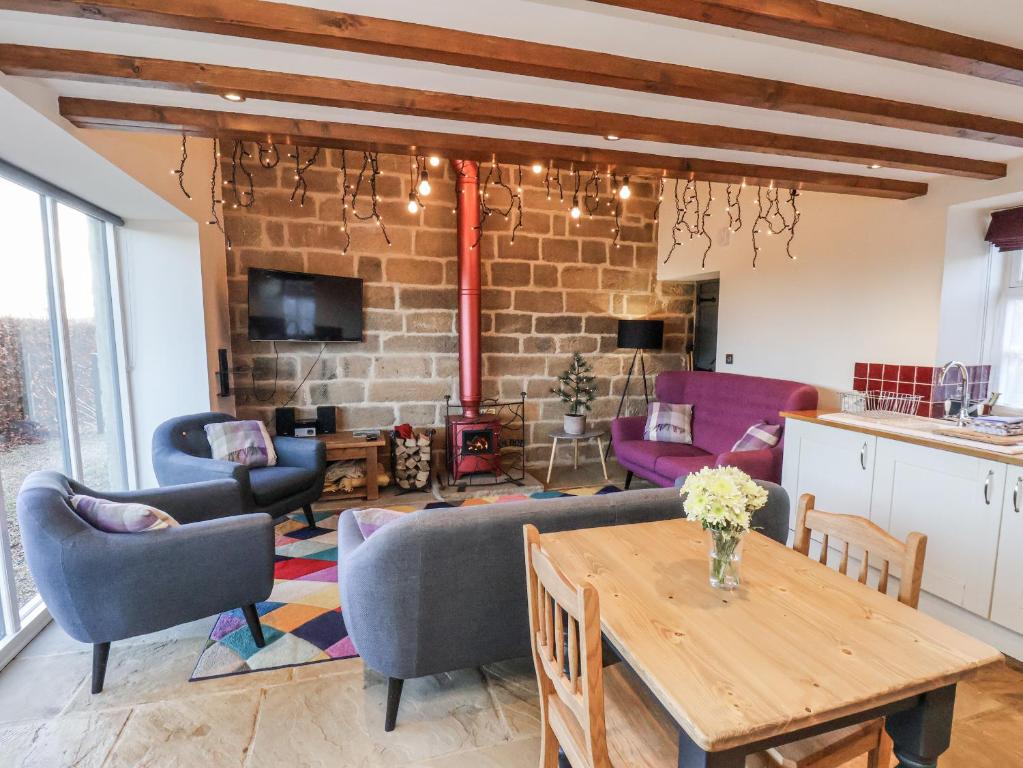 a living room with a table and chairs at Chestnut Barn in Whitby