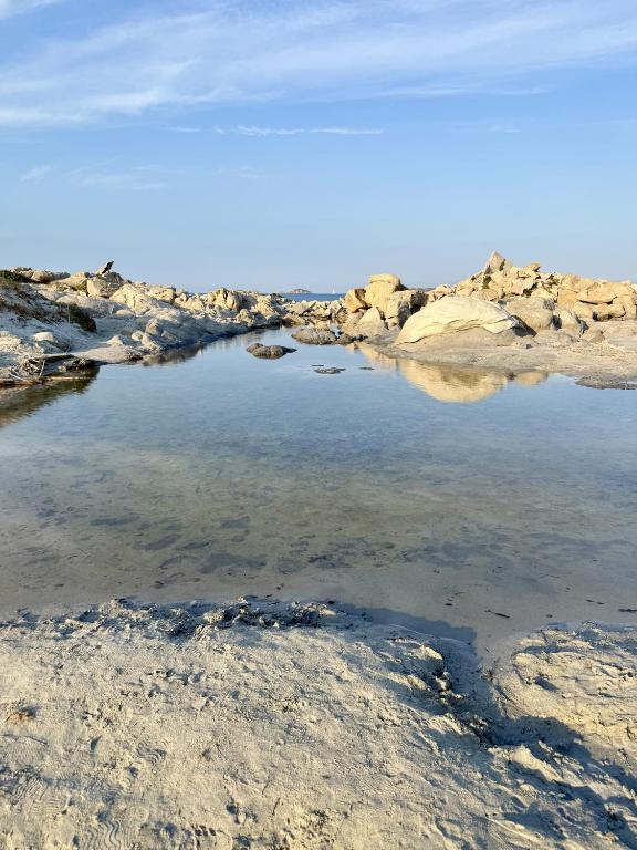 a body of water with rocks in the water at Home Nicola Jago in Castiadas