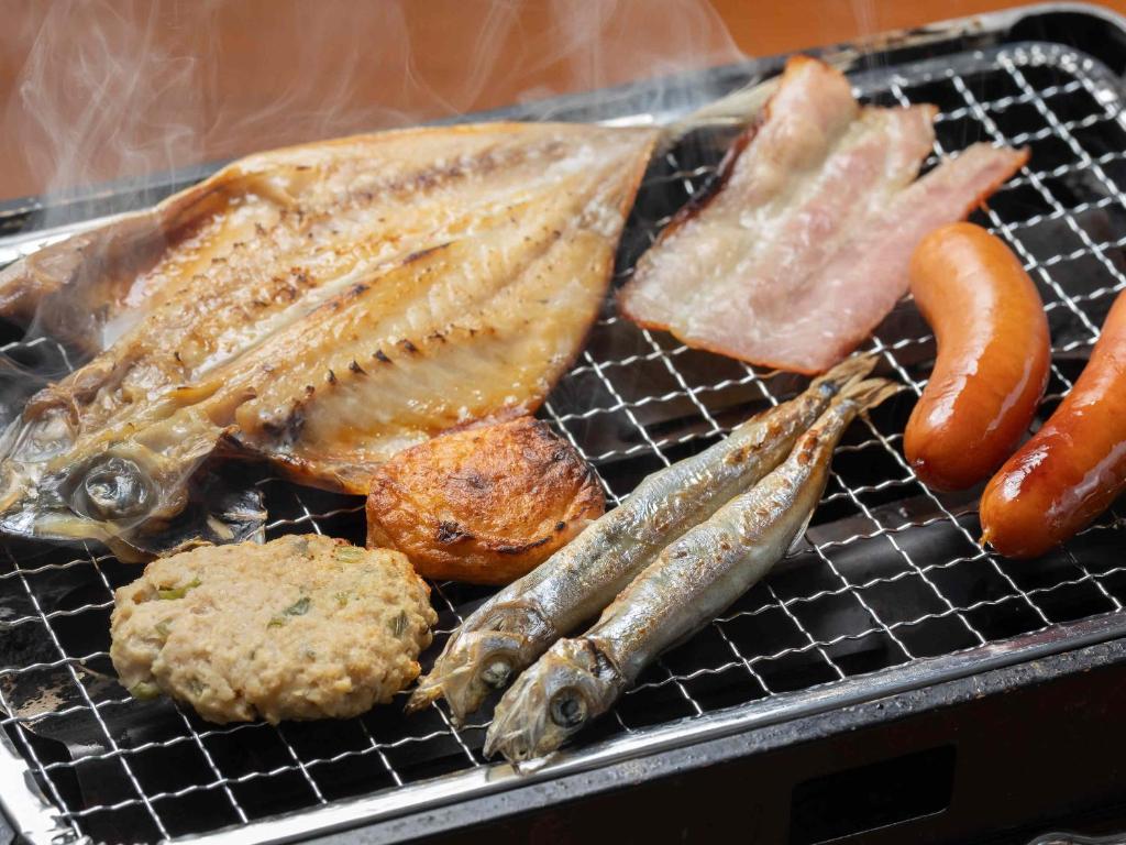 a grill with fish and other foods on it at Shirahama Ocean Resort in Minamiboso