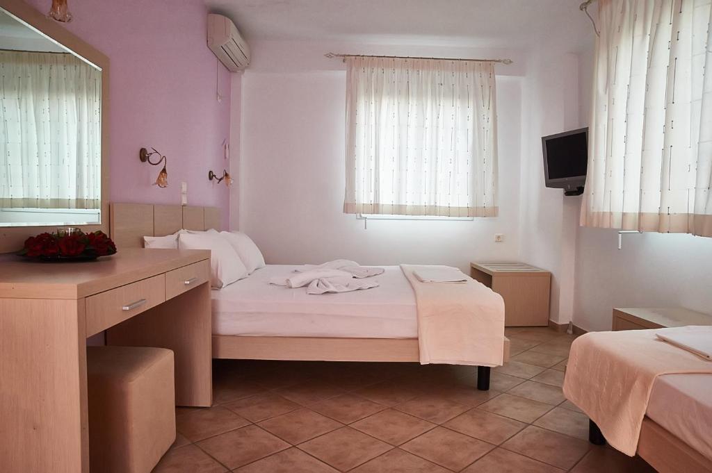 Postel nebo postele na pokoji v ubytování Villa Aroni