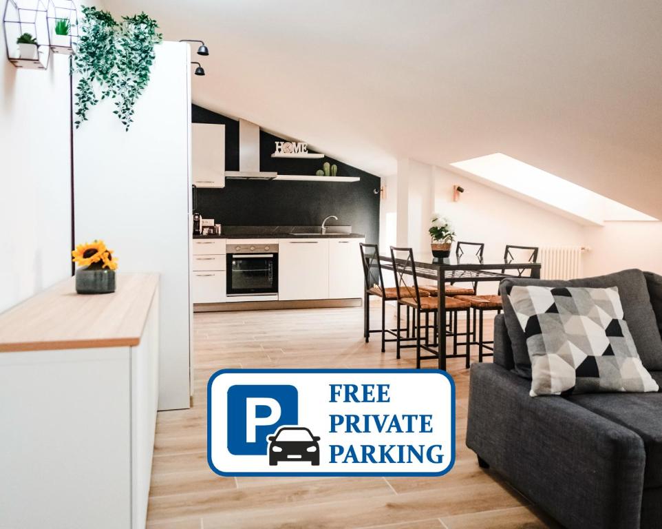 a kitchen and a living room with a free private parking sign at Mansarda Belli Ravenna in Ravenna