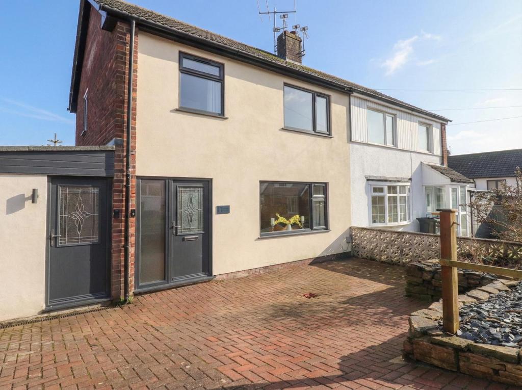 a house with black doors and a brick driveway at Thieveley Pike View in Burnley
