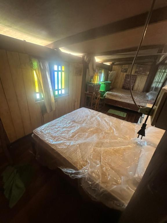 a bedroom with a bed covered in plastic at Tan Homestay in Ko Lanta