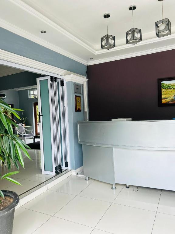 a hair salon with a white reception desk at ZQ Guest House in Mthatha
