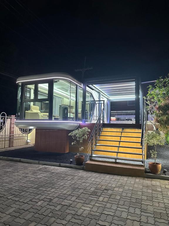 a house with stairs and a building with lights at Luxury Capsule Haus Phuket in Panwa Beach