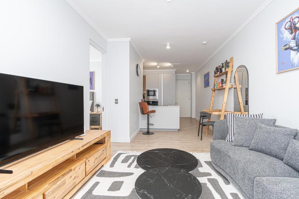 a living room with a large flat screen tv at Elegant AirConditioned Neria at Ellipse Waterfall in Midrand