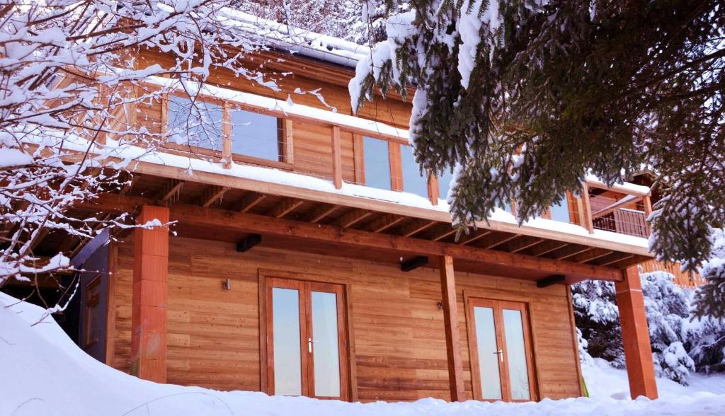 a log cabin in the snow with snow at Boutique Alpine Chalet with Panoramic Views in Thollon