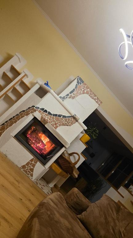 a living room with a table with a tv on it at Ferienwohnung Baumgartner in Aigen im Ennstal