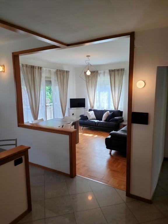 a living room with a table and a couch at Marconi 33A in Pergine Valsugana