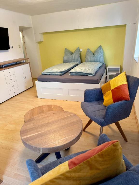 a room with a bed and a table and chairs at Haus Anna in Köttwein