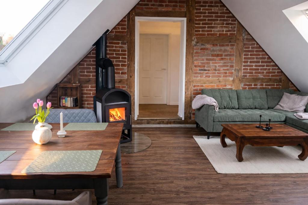 a living room with a couch and a fireplace at Lysholm Living Luttmersen Ferienwohnung in Neustadt am Rübenberge