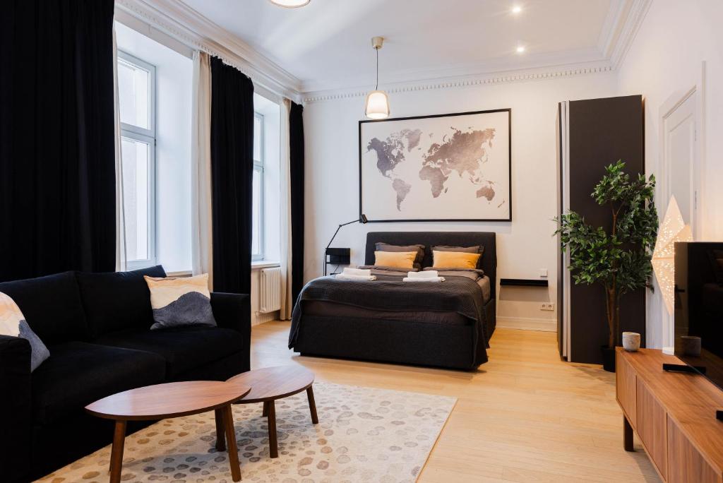 a living room with a couch and a table at Luxury Central Riga Studio, Raina Nams in Riga