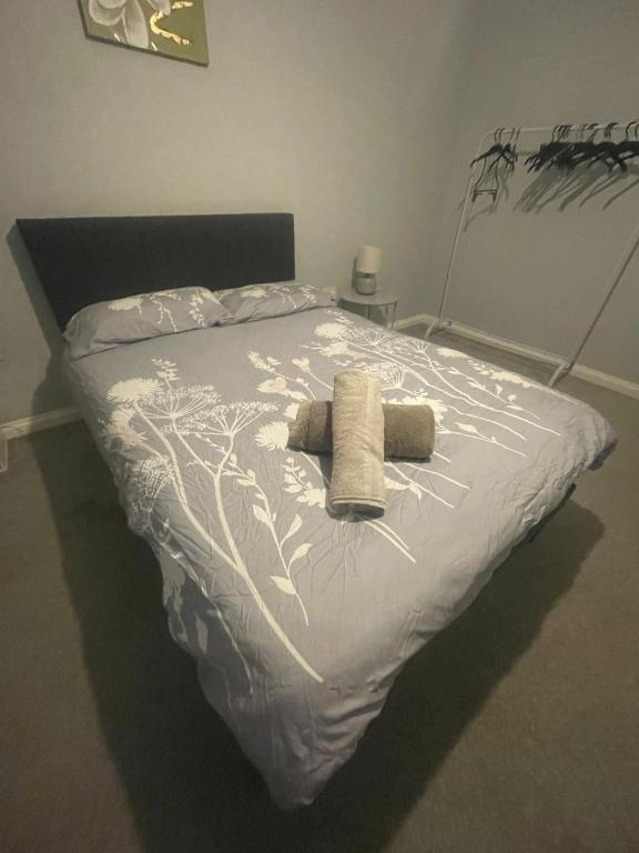 a bedroom with a bed with a white comforter at Modern 3-Bed House in Ramsgate Close to Seafront in Ramsgate