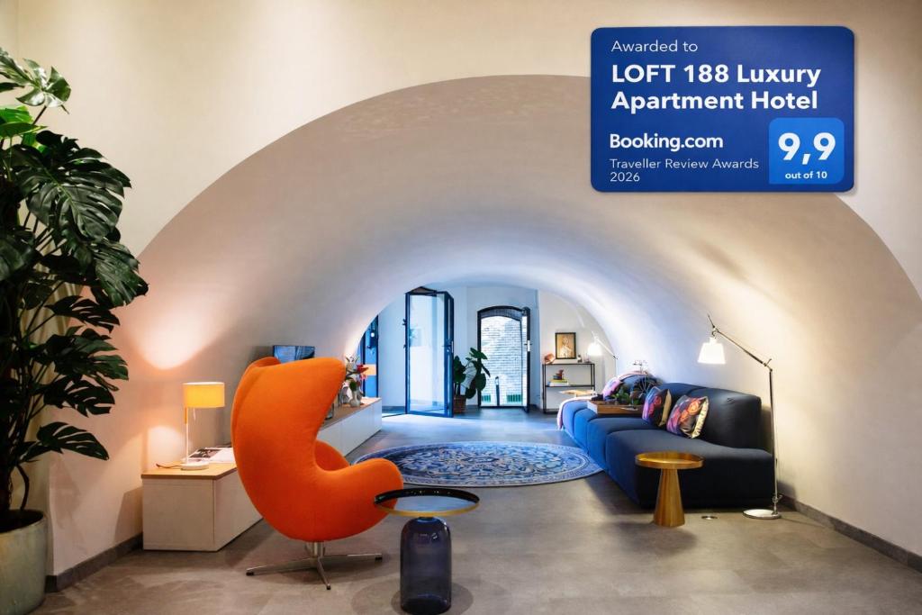 a living room with a blue couch and an orange chair at LOFT 188 Luxury Apartment Hotel in Utrecht