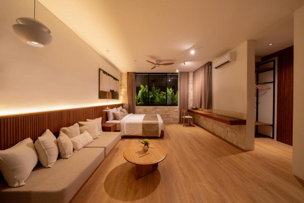 a hotel room with a bed and a couch at Sawo Villa Canggu - Private Brand New 2BR Villa in Canggu