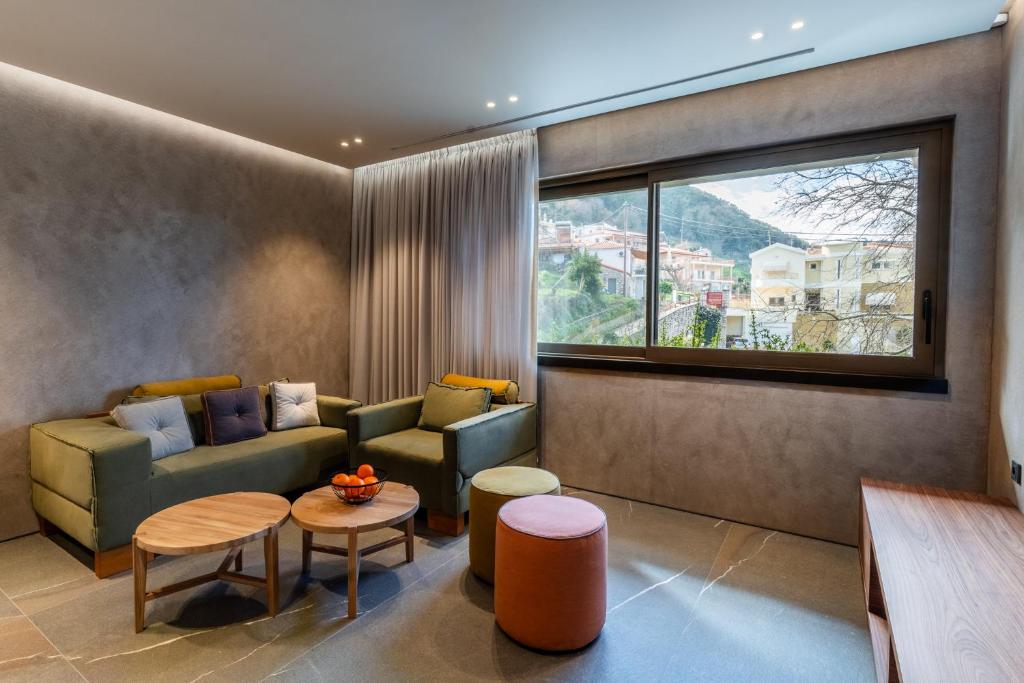 a living room with a couch and a table at Selemnos Boutique in Patra