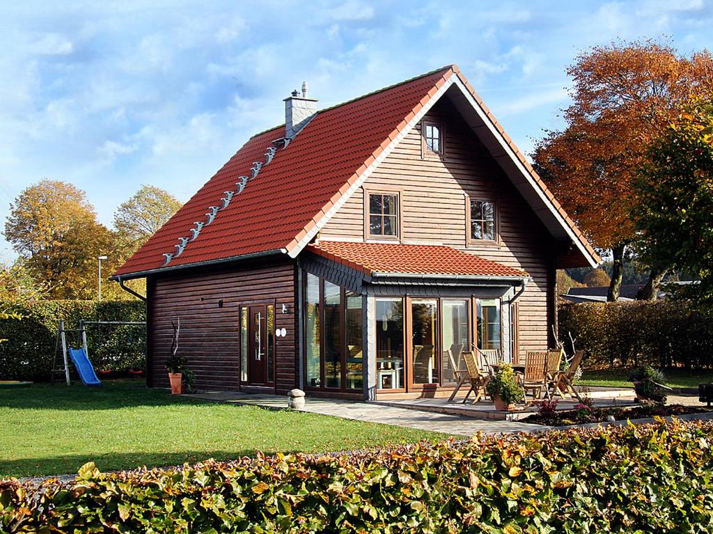 a house with a red roof on a yard at Eifelhof Bock in Hürtgenwald