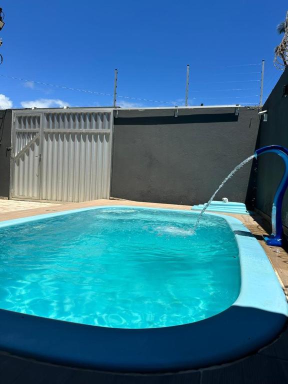 a swimming pool with a water fountain at Descanso Milagres in São Miguel dos Milagres