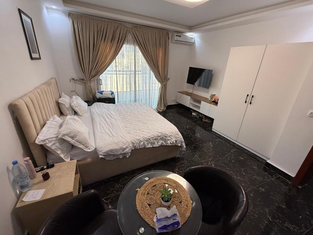 a hotel room with a bed and a living room at Sylla in Dakar