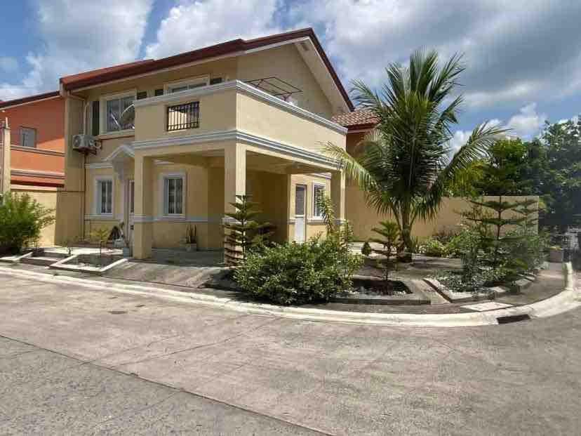 a house with a palm tree in front of it at AD3M Haven's Place in Bantug