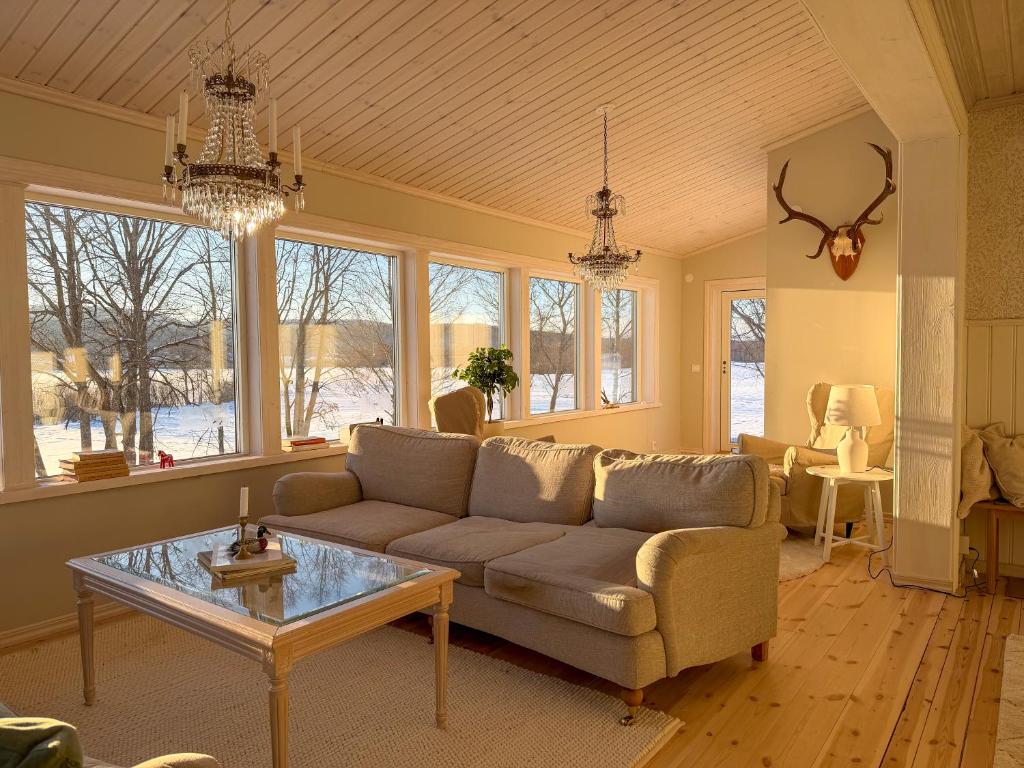 a living room with a couch and a table at Secluded Lakehouse in Falun