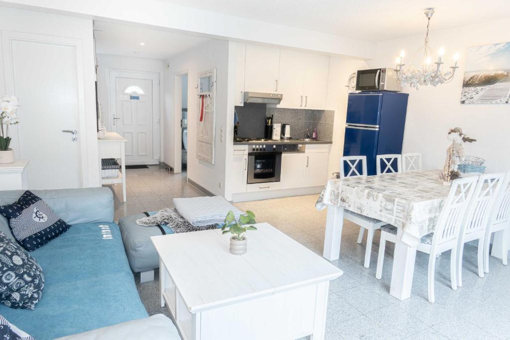 a living room with a blue couch and a table at Ferienhaus Ostsee in Pruchten
