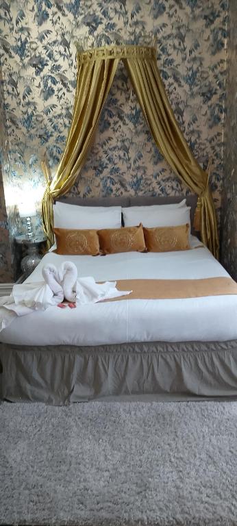 a bed with two stuffed animals sitting on it at The Celtic Pride Hotel in Blackpool