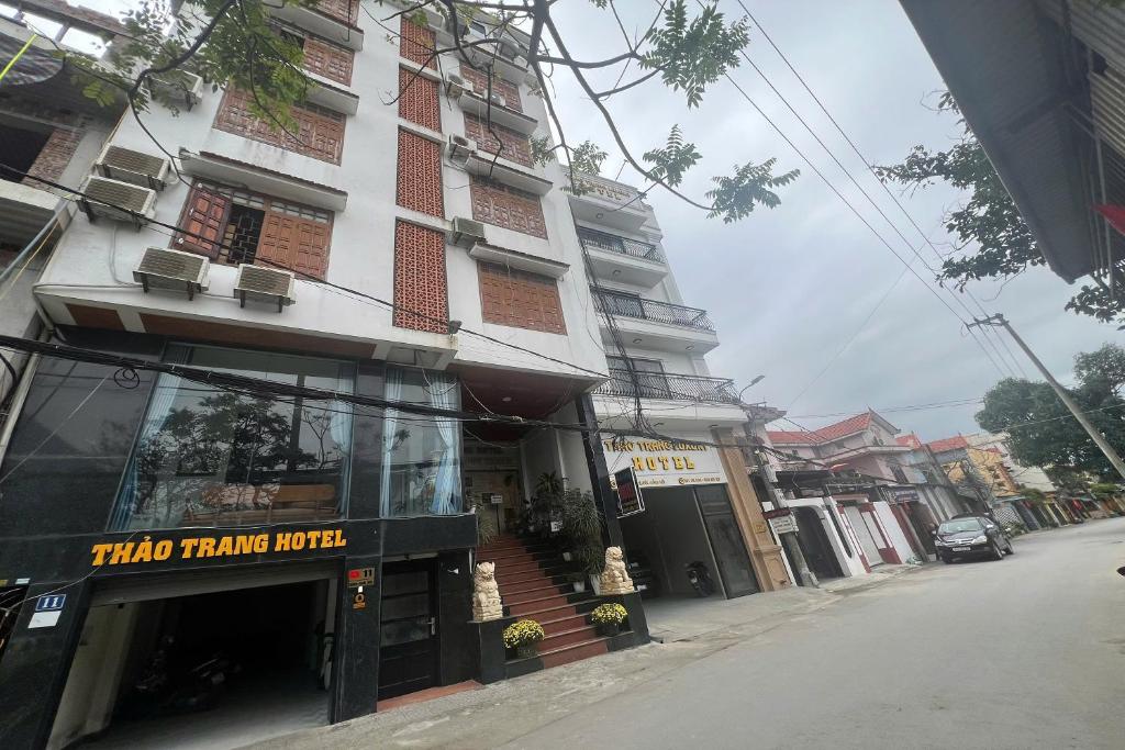 a building on a city street with a store at Thao Trang Hotel in Dong Hoi
