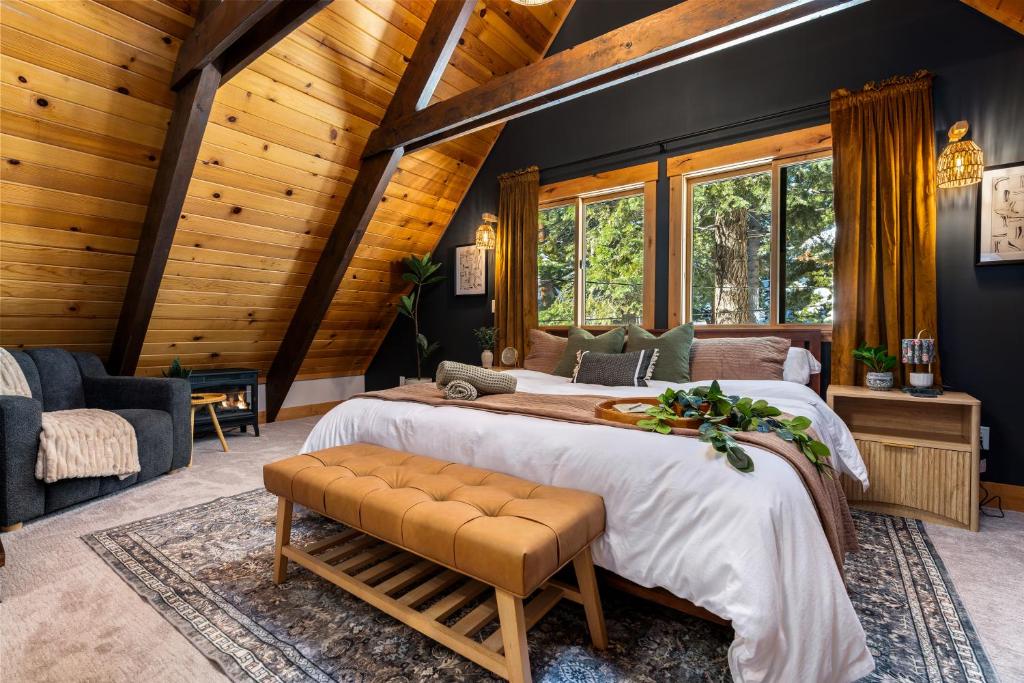 a bedroom with a large bed in a room with wooden walls at Starlight Chalet Lake Tahoe in Carnelian Bay