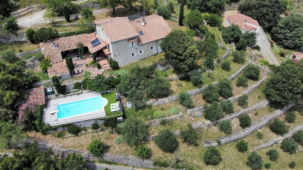 an aerial view of a house with a swimming pool at La Rochere in Sampzon