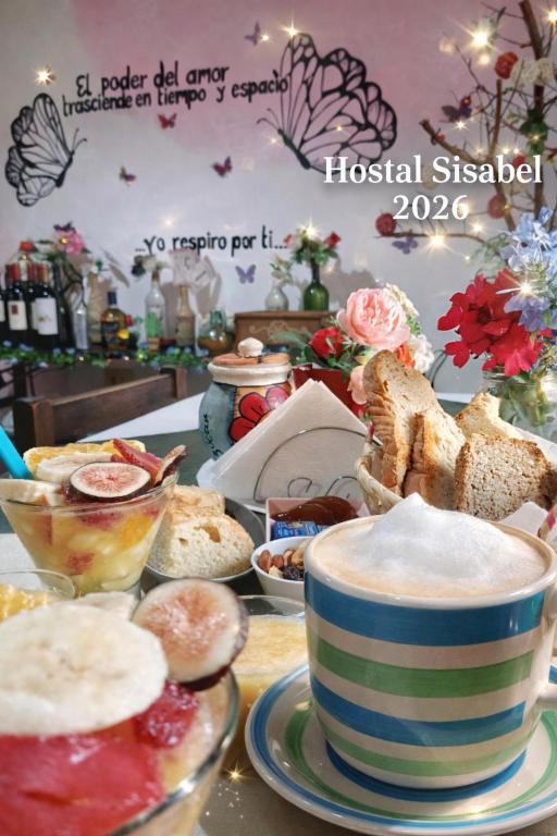 a table with a cup of coffee and a plate of bread at Hostal Sisabel in Tinogasta