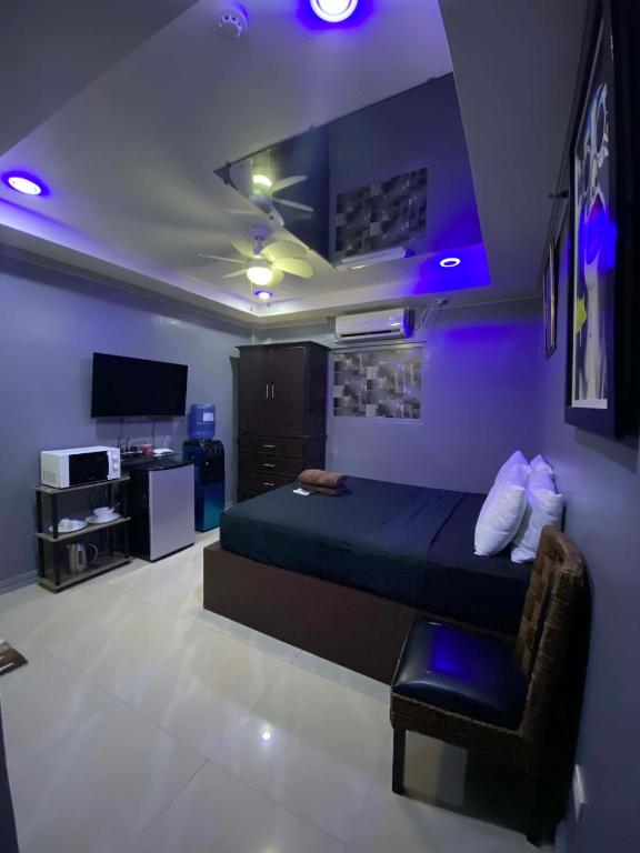 a bedroom with a bed and a purple ceiling at Bourbon street condo39A in Angeles