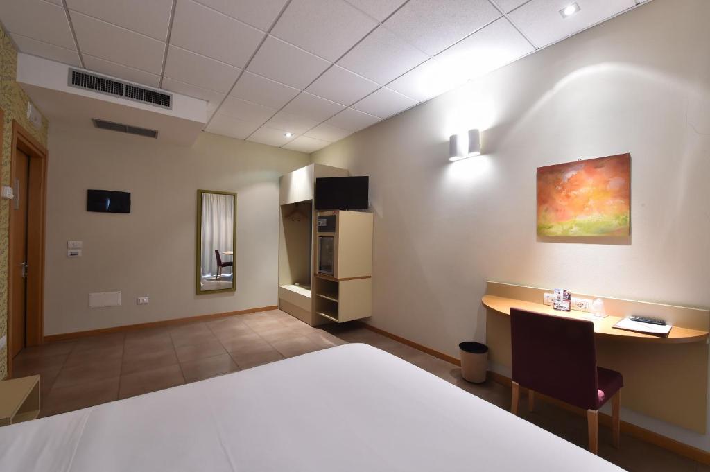 Postel nebo postele na pokoji v ubytování Tatì Hotel