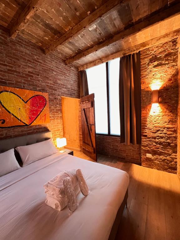 a bedroom with a bed with two shoes on it at Emmeloft I Orange Moon - Vibrant Modern Luxury Loft Milan in Milan