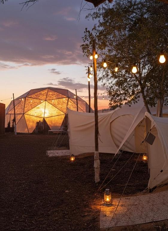 a couple of tents in a park at dusk at Desert HoM by GLOW in Naẖal Shittim