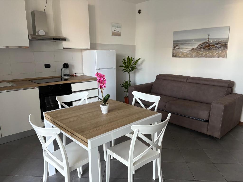 a kitchen and living room with a table and a couch at Casa Menotti in Carate Brianza