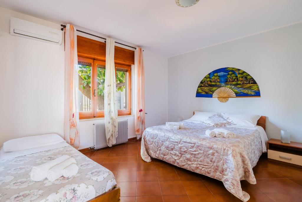 a bedroom with two beds and a window at Casa Fortuna in Gallipoli