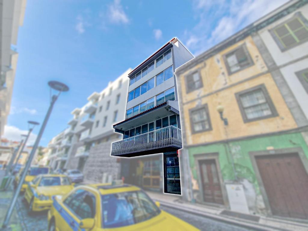 a yellow car is parked on a city street at Funchal Paradise in Funchal