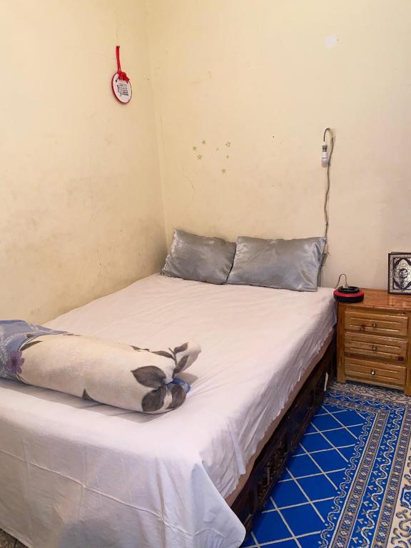 a bedroom with two beds and a wooden dresser at GUESTS Of TATA in Tatta