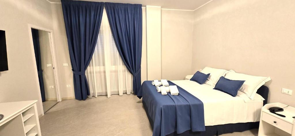 a bedroom with a bed with two teddy bears on it at HOTEL PARADISO in Altedo