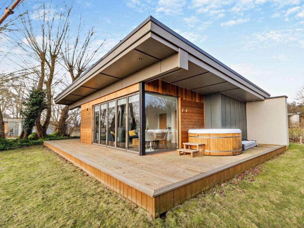 a house with a large deck with a hot tub at 2 Bed in Colchester oc-95941 in East Bergholt