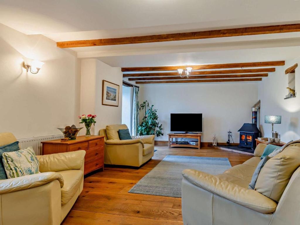 a living room with couches and a flat screen tv at 4 Bed in Boscastle oc-47035 in Boscastle