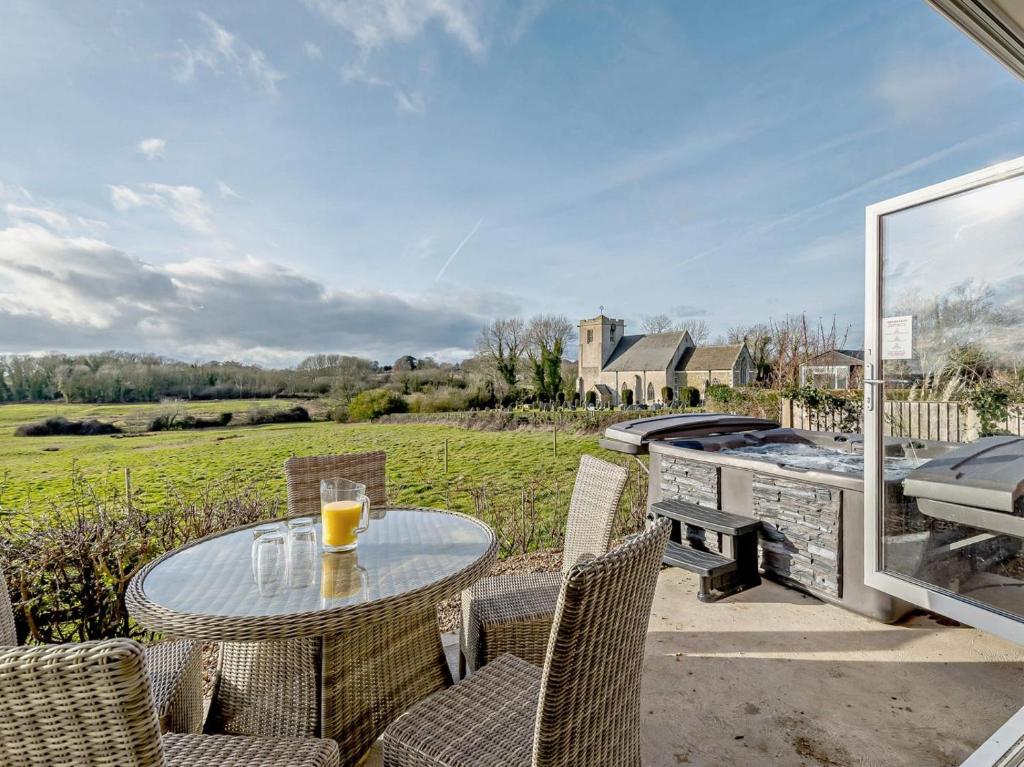 a patio with a table and chairs and a grill at 3 Bed in Spilsby oc-91142 in Skendleby
