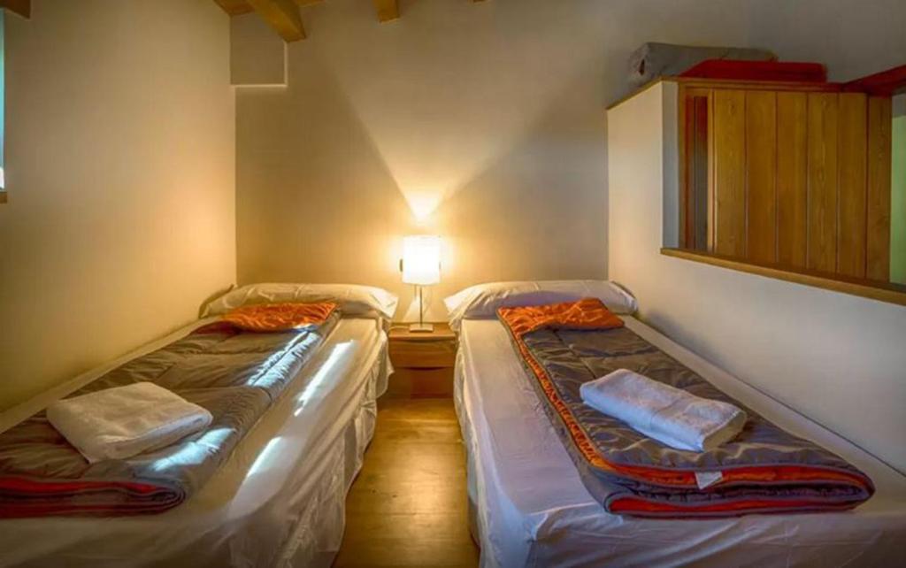Postel nebo postele na pokoji v ubytování CasaCampelles II - Vall de Núria - Ripollès