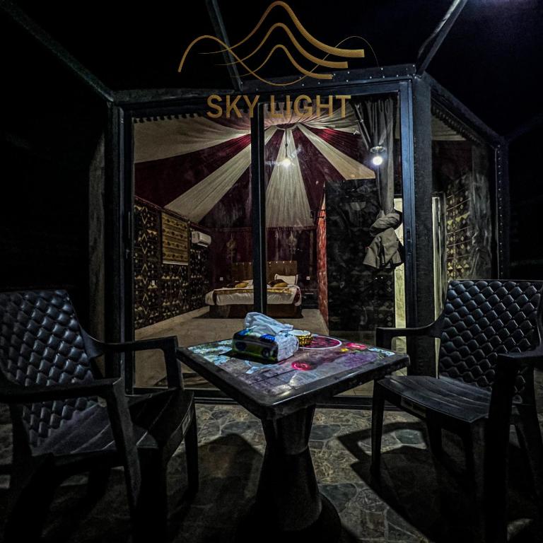 a room with a table and two chairs at Skylight Wadi Rum Camp in Disah