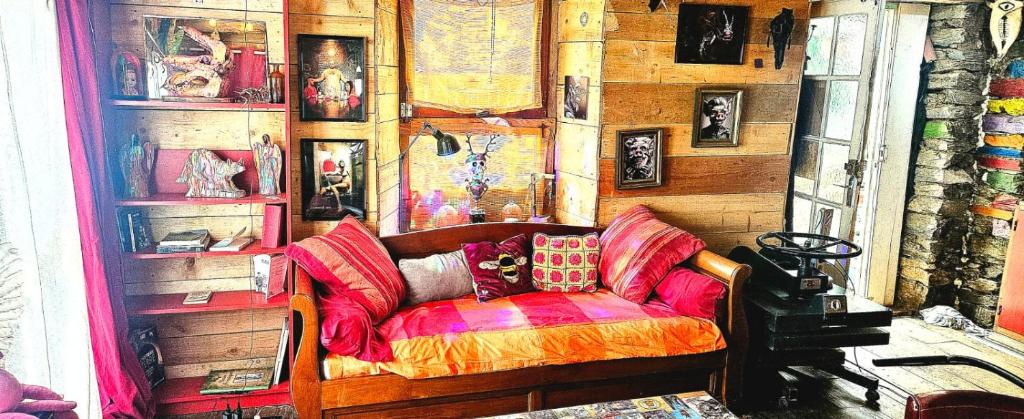 a living room with a couch and pictures on the wall at L'atelier de joakim in Seix