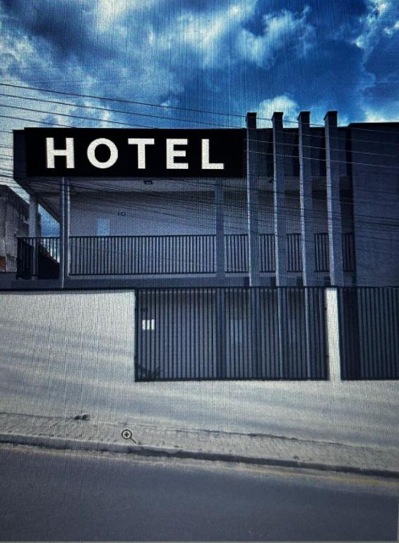 a hotel sign on the side of a building at Hotel dallas in Telêmaco Borba